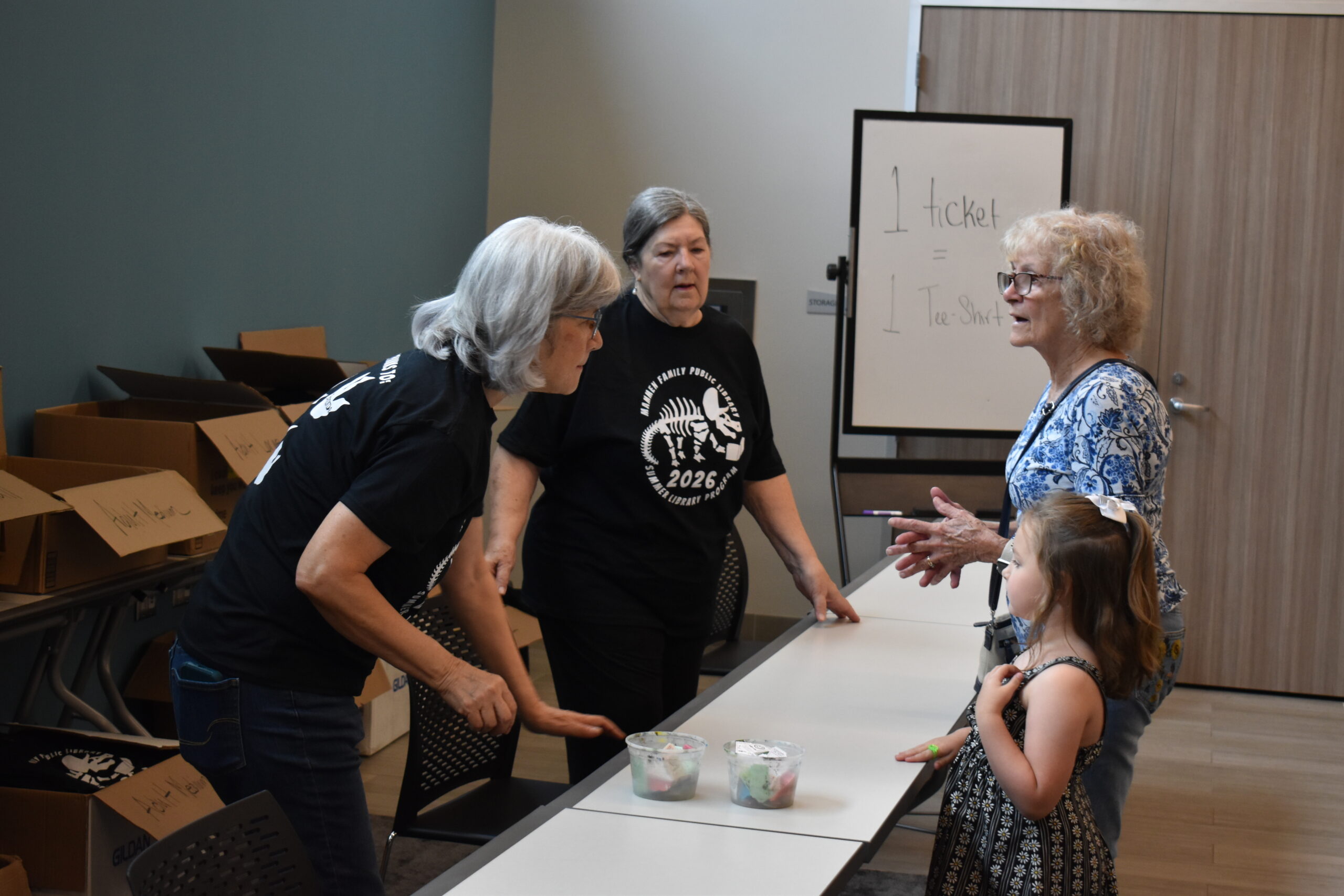 adult volunteering at local library